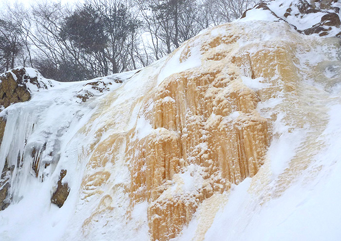 Winter activity example: Yellow Falls Tour. An ice waterfall created by the crater wall.